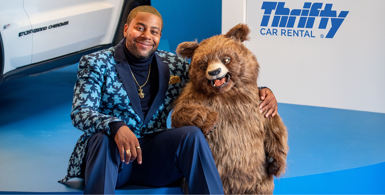 Thrifty car-rental campaign with talent and a bear mascot beside the Thrifty logo.